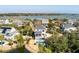 Aerial view of a beautiful home with an in-ground pool, marsh views, and lush landscaping at , Charleston, SC 29412
