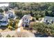 Lovely aerial view of a two-story home with a charming front yard and long driveway amidst lush greenery and neighborhood charm at , Charleston, SC 29412