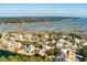Aerial view of waterfront home with a pool surrounded by lush landscaping and scenic waterway views at , Charleston, SC 29412