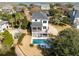Gorgeous aerial view of a modern two-story home featuring a pool, waterfront views, and a well-maintained yard at , Charleston, SC 29412