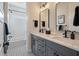 Bathroom with dual sinks, modern fixtures, and stylish black and white patterned floor at , Charleston, SC 29412