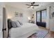 Bright bedroom featuring hardwood floors, stylish rug, comfortable bedding, and access to a private balcony at , Charleston, SC 29412
