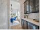 Chic butler pantry with dark cabinets, glass storage, and quartz countertops at , Charleston, SC 29412