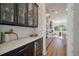 Elegant butler pantry with wine fridge, black accents, and a view of the dining area at , Charleston, SC 29412