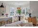Bright dining area has large windows for natural light, a modern chandelier, and an adjacent kitchen area at , Charleston, SC 29412
