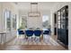 Dining room featuring a large wood table, blue chairs, modern chandelier, and bright windows at , Charleston, SC 29412
