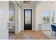 Inviting entryway with wood floors, and a view out the black front door at , Charleston, SC 29412