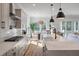 Bright kitchen with an island featuring seating, stainless appliances, modern pendant lighting, and an eat-in area at , Charleston, SC 29412