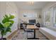 Well-lit home office with a large window, built-in shelving, and comfortable seating at , Charleston, SC 29412