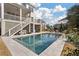 Inviting backyard pool featuring stylish light gray tile, surrounded by a lush lawn and manicured landscaping at , Charleston, SC 29412