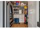Well-organized walk-in closet with custom shelving, drawers, and a distinctive black and white striped accent wall at , Charleston, SC 29412