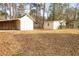 Backyard featuring two white storage sheds and a large yard at 105 Pinewood St, Walterboro, SC 29488