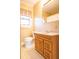 Bathroom with a sink, toilet, window, and large mirror at 105 Pinewood St, Walterboro, SC 29488