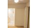 Bedroom featuring light walls, carpet, and a door that leads to a white tiled bathroom at 105 Pinewood St, Walterboro, SC 29488