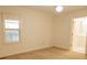 Bright bedroom featuring light walls, carpet, a window with curtains, and a door that leads to a bathroom at 105 Pinewood St, Walterboro, SC 29488