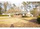 View of the home's front exterior, displaying the brick facade and landscape at 105 Pinewood St, Walterboro, SC 29488
