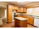Kitchen featuring an island, laminate countertops and wooden cabinets at 105 Pinewood St, Walterboro, SC 29488