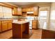 Kitchen boasts wooden cabinetry, an island, and modern appliances at 105 Pinewood St, Walterboro, SC 29488