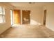 Bright living room with light walls, carpet, a vintage ceiling fan, and a wooden front door with sidelight at 105 Pinewood St, Walterboro, SC 29488
