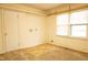Room with hardwood flooring, windows, and access to another room at 105 Pinewood St, Walterboro, SC 29488