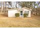 Exterior view of a backyard storage shed with a green door at 105 Pinewood St, Walterboro, SC 29488