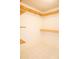 Walk-in closet featuring white walls, light tile floor, and wood shelving at 105 Pinewood St, Walterboro, SC 29488