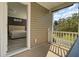 Bedroom balcony overlooking a green backyard with trees and lush landscaping at 110 Instructor Ct, Ladson, SC 29456