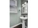 Powder room with pedestal sink, decorative mirror, neutral colors and natural light at 110 Instructor Ct, Ladson, SC 29456