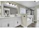 Bright bathroom features a double vanity with marble countertop, soaking tub, and a glass-enclosed shower at 110 Instructor Ct, Ladson, SC 29456
