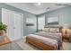Bedroom features light blue walls, carpet, one window, a closet with double doors, and a queen-size bed at 110 Instructor Ct, Ladson, SC 29456