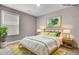 Bedroom features gray walls, carpet, one window, a queen-size bed, and a nightstand with lamps at 110 Instructor Ct, Ladson, SC 29456