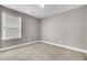 An empty bedroom with gray walls, neutral carpet, and a window at 110 Instructor Ct, Ladson, SC 29456