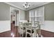 Dining room with hardwood floors, white wainscoting, chandelier, and view to kitchen at 110 Instructor Ct, Ladson, SC 29456