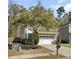 Two-story home with a two-car garage, a small porch, and mature landscaping at 110 Instructor Ct, Ladson, SC 29456