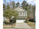 Charming two-story home with a two-car garage, mature trees, and a well-maintained lawn at 110 Instructor Ct, Ladson, SC 29456