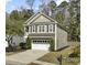 View of a two-story home featuring neutral siding, white trim, and a two-car garage at 110 Instructor Ct, Ladson, SC 29456