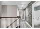 Upstairs hallway with stone accent wall, light hardwood floors and neutral paint at 110 Instructor Ct, Ladson, SC 29456