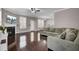 Open living room showcasing hardwood floors, a cozy fireplace, and a ceiling fan at 110 Instructor Ct, Ladson, SC 29456