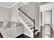 Open living room with staircase, hardwood floors and comfortable neutral-toned sofa at 110 Instructor Ct, Ladson, SC 29456