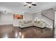 Bright living room featuring hardwood floors, a comfortable couch, and an open layout to the kitchen at 110 Instructor Ct, Ladson, SC 29456