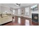 Spacious living room showcasing hardwood floors, lots of natural light, and a fireplace with mounted TV at 110 Instructor Ct, Ladson, SC 29456