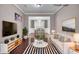 Cozy living room staged with modern furniture and decor open to the dining area at 110 Instructor Ct, Ladson, SC 29456