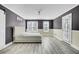 Bedroom with neutral walls, light gray floors, and a white barn door at 110 Instructor Ct, Ladson, SC 29456