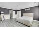 Bedroom with neutral walls, light gray floors, and a white sliding barn door at 110 Instructor Ct, Ladson, SC 29456