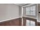 Empty room with hardwood floors, neutral paint, white trim, and a bright window at 110 Instructor Ct, Ladson, SC 29456
