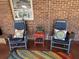 Charming covered back porch featuring rocking chairs and colorful decor at 111 Newington Rd, Summerville, SC 29485