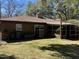 Brick home backyard with a well-maintained lawn and mature trees, creating a private outdoor oasis at 111 Newington Rd, Summerville, SC 29485