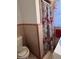 Bathroom features a floral shower curtain, pink tiles, and natural light streaming through the window at 111 Newington Rd, Summerville, SC 29485