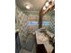 Bathroom showcasing mosaic tile floor, a wood-paneled wall, and a vanity with a sink at 111 Newington Rd, Summerville, SC 29485