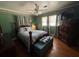 Bedroom featuring a four-poster bed, dresser, hardwood floors, and floral wallpaper border at 111 Newington Rd, Summerville, SC 29485